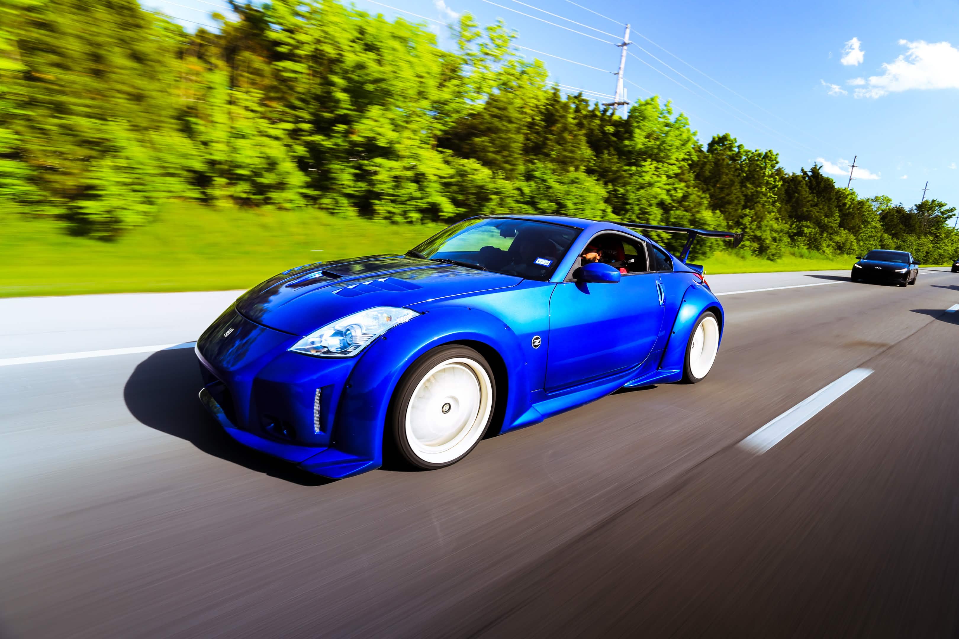 Blue Nissan 350Z widebody rolling highway Indiana Welchiani Media